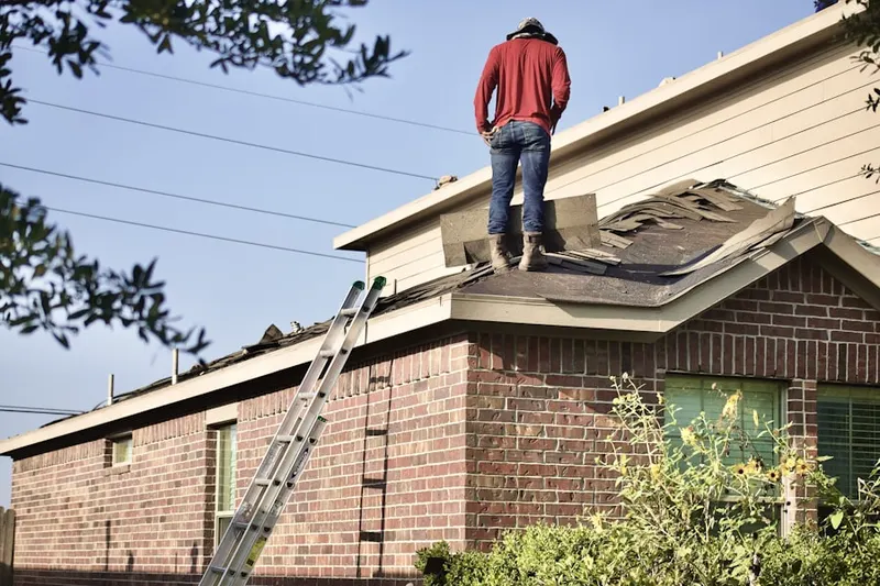 Professional roofer working on a residential roof in Hollow Hills